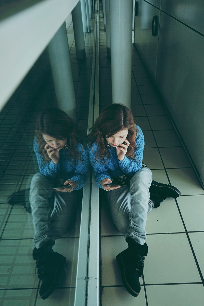 Young woman alone and tired in a bus station